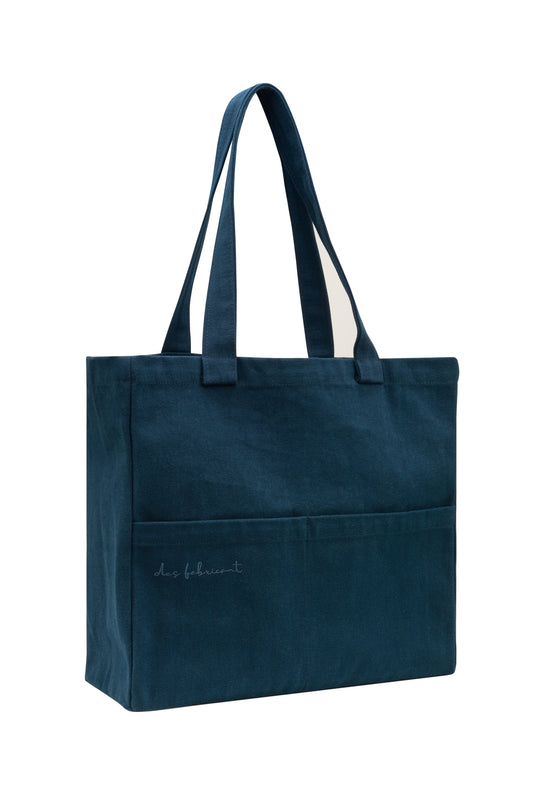 Dark blue cotton tote bag with dual front pockets and long handles - minimalist, washable,eco-friendly design by Des Fabricant.