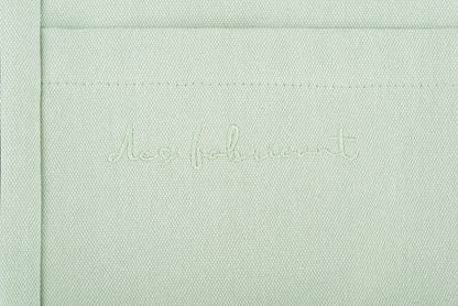 Close-up of Des Fabricant logo embroidery on premium seafoam green cotton - subtle and
refined brand detailing.