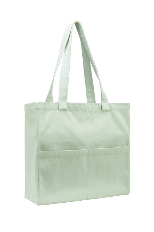 Seafoam green cotton tote bag with front pockets and wide handles - washable, sustainable, and minimalist design by Des Fabricant.